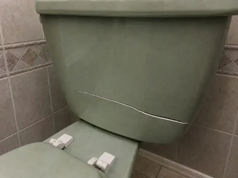 Green ceramic toilet cistern with a split front panel